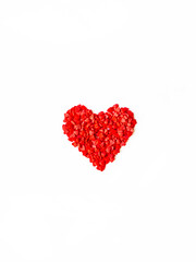 Obraz na płótnie Canvas Valentine's card. Red heart made of small hearts pastry sprinkles on white background.