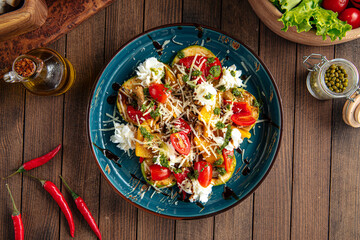 Grilled vegetables salad with cheese on wooden background