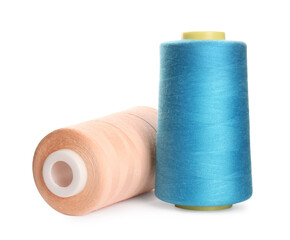 Different colorful sewing threads on white background