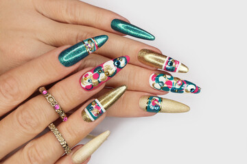 Manicure on long nails with rhinestones and design.