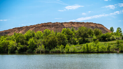 Hilly island with green leslm across the river.