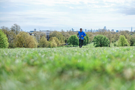 Mature man jogging at public park during sunny day