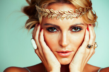 young blond woman dressed like ancient greek godess, gold jewelry close up isolated, beautiful girl...