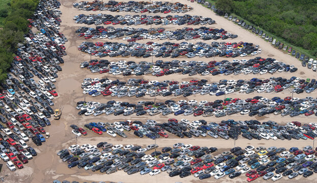 Aerial view of junkyard filled with various cars