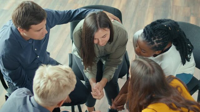 View From Above. A Group of People Sitting in a Circle During a Group Therapy Session. Woman Sharing Traumatic Experience, Receiving Support From People of Mixed Race. Addiction, Psychological Help.