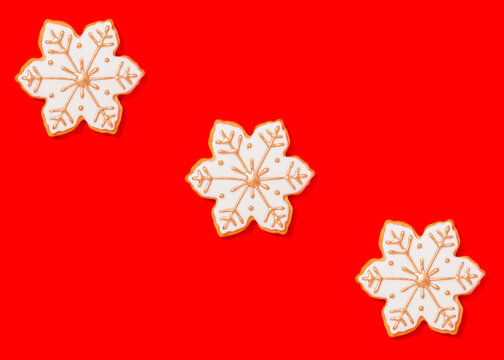 Three snowflake shaped Christmas cookies against vibrant red background