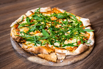 Closeup of Cheese and vegetable pizza in plate on wooden table