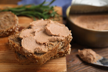 Fresh bread with delicious meat pate on wooden table, closeup