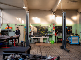 Female mechanic with document working in car repair shop