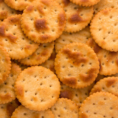 pile of spicy biscuits, crispy and crunchy crackers, tea time snack background, closeup view taken from above