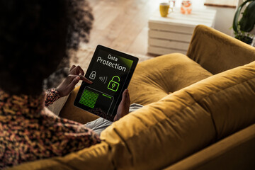 Woman unlocking device while sitting on sofa