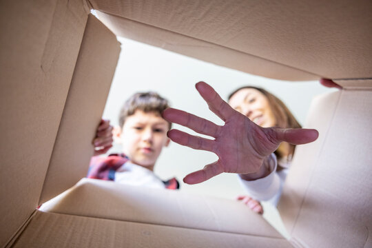 Mother Putting Hand In Surprise Box By Son