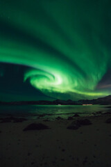 Fototapeta na wymiar Northern lights known as aurora borealis over the arctic landscape in Norway. High quality photo