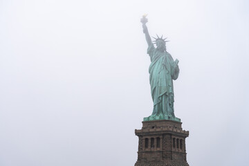 Statue of Liberty on a foggy winter day, New York City, USA