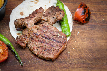 grilled red meat on wooden serving board