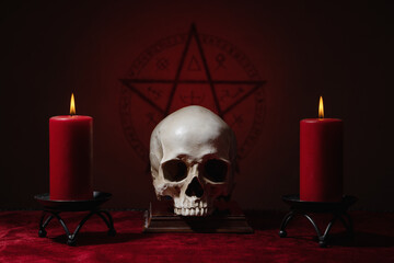 Pentagram symbol, human skull and candles. Black magic ritual or spell with occult and esoteric...