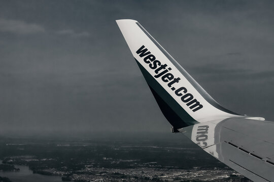 Westjet Logo In Plane Wing, Black And White