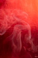 Smoke, smoke rising and creating beautiful shapes and a red background, Selective focus.