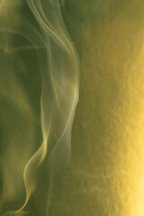 Smoke, smoke rising and creating beautiful shapes and a yellow background, Selective focus.