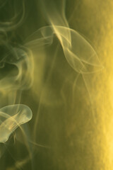 Smoke, smoke rising and creating beautiful shapes and a yellow background, Selective focus.