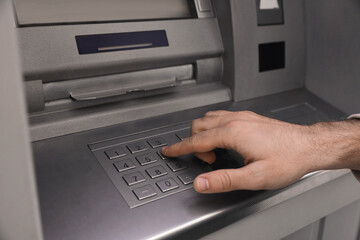 Man entering cash machine pin code, closeup