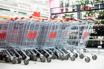 row of shopping carts in the entrance of supermarket
