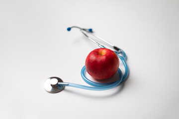stethoscope and fresh raw fruit flat lay as the symbol of alternative medicine