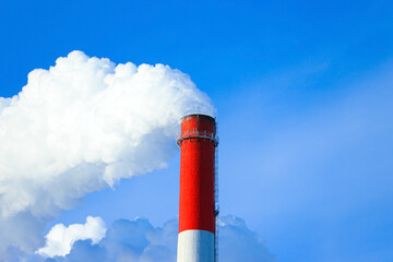 Pollution, emissions - thick smoke is coming out of the pipe into the atmosphere