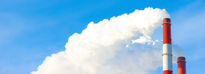 Pollution, emissions - thick smoke is coming out of the pipe into the atmosphere