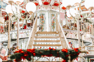 Carousel for children, at Christmas fair in the evening, with lights and animated colors for the...