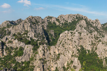 Scenic landscape view of limestone mountain with cliff in tropical forest.