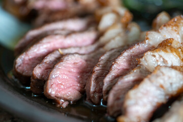 Close up liced grilled medium rare beef steak. Barbecue, bbq meat beef tenderloin. Shallow depth of field.