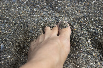 Barefoot without pedicure on the sand