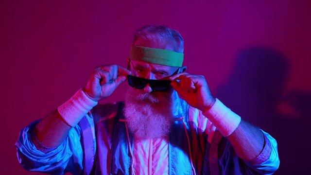 Retired grandfather serious expression ready dance battle street stunt dark late