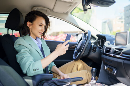 Female professional using smart phone while sitting in car