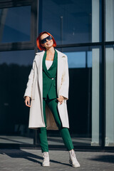 Beautiful woman posing in autumn coat posing in the street