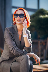 Elderly business woman in grey suit outdoors