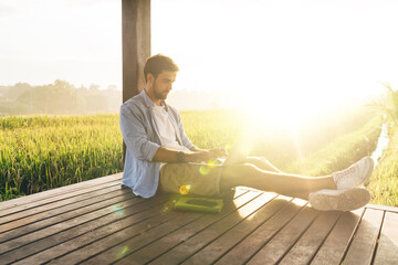 Man working remotely on laptop in nature
