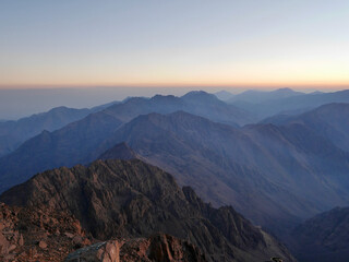 Naklejka na ściany i meble Breathtaking view from the top of Djebel Toubkal, North Africa's highest mountain, at sunrise. Morocco.