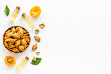 Apricot kernel oil with ripe apricot fruits, top view