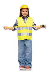 building, construction and profession concept - smiling little girl in protective helmet and safety vest with ruler over white background