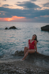 Fototapeta na wymiar sexy woman enjoying view of sunset above the sea