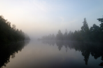 Fototapeta na wymiar Lake with trees reflecting in water