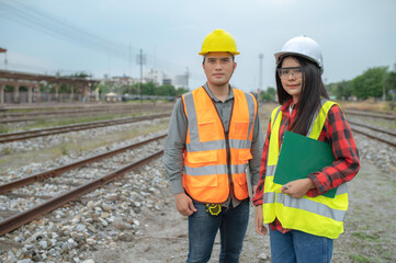 Two engineer working at train station,Work together happily,Help each other analyze the problem,Consult about development guidelines