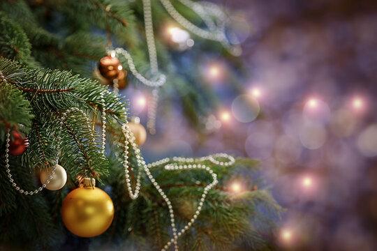 Christmas decorations and lights on the Christmas tree, blur background with free space 