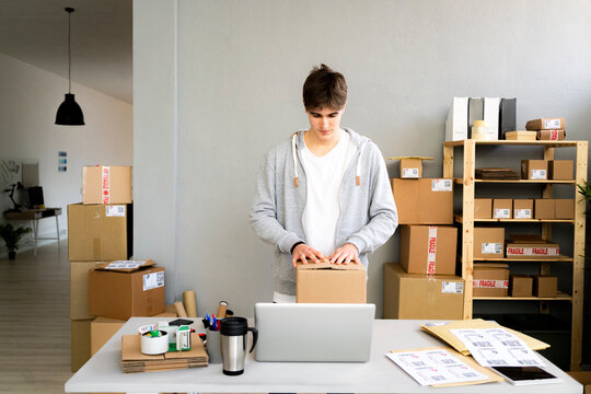 Businessman packing box at desk in office