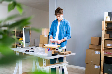 Male professional scanning bar codes at desk in office