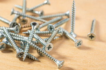 universal screws for wood on a wooden background
