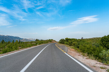 Scenic road. The road is surrounded by a magnificent natural landscape.