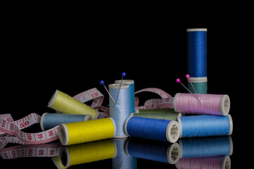 Colourful sewing threads background closeup